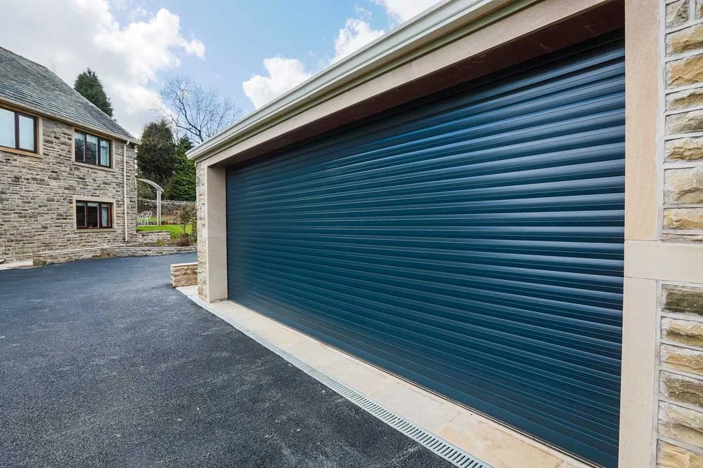 Blue roller garage door on a stone house